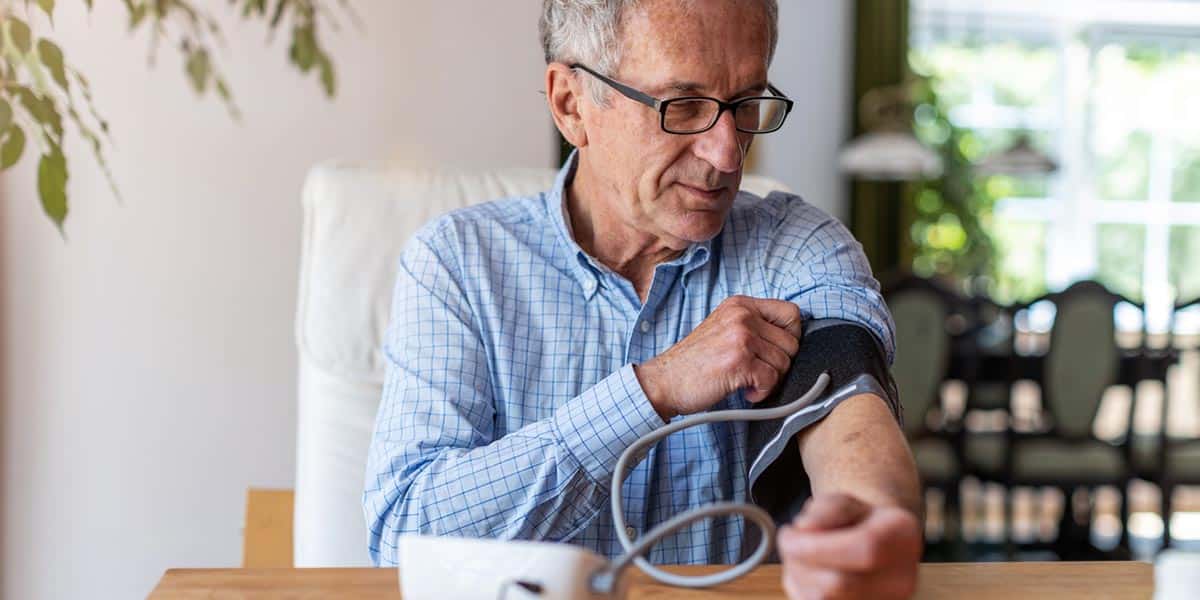 elderly man taking a blood pressure reading