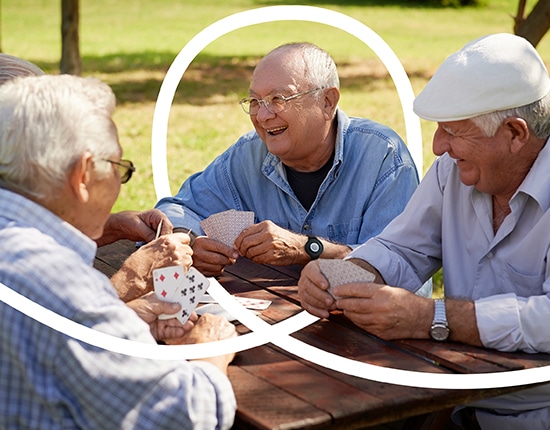 Man Wearing PERS Playing Cards with Friends